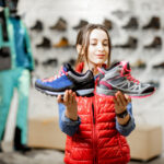 Vysoké a nízke turistické topánky položené na horskom chodníku